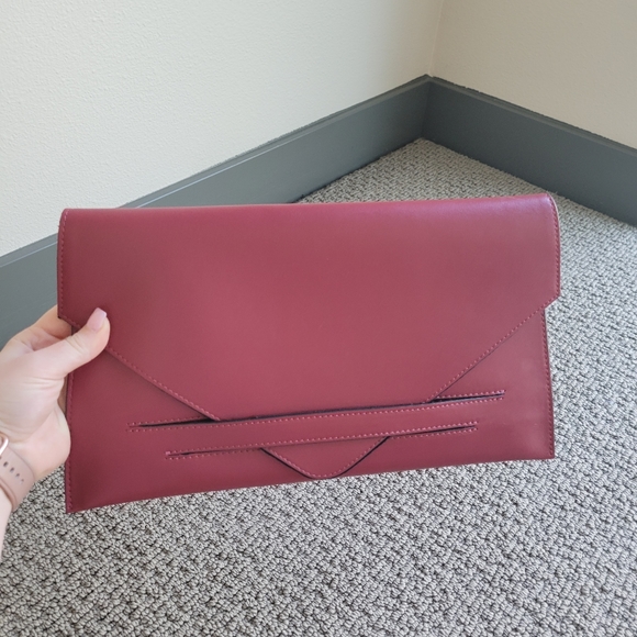 Maroon clutch with gold chain crossbody